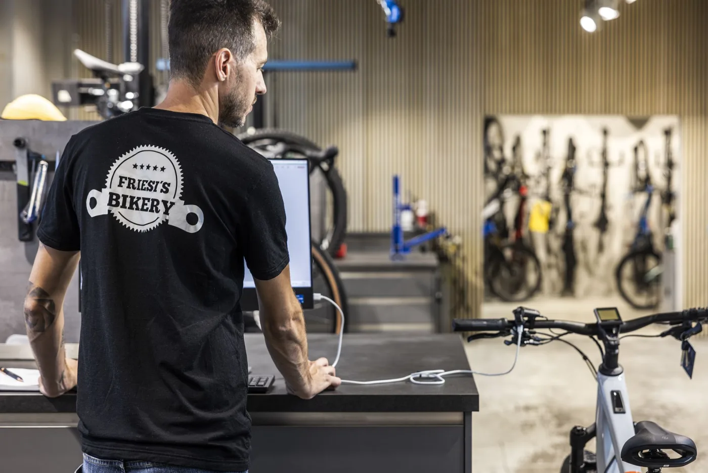 A staff member working at the point-of-sale terminal in the shop